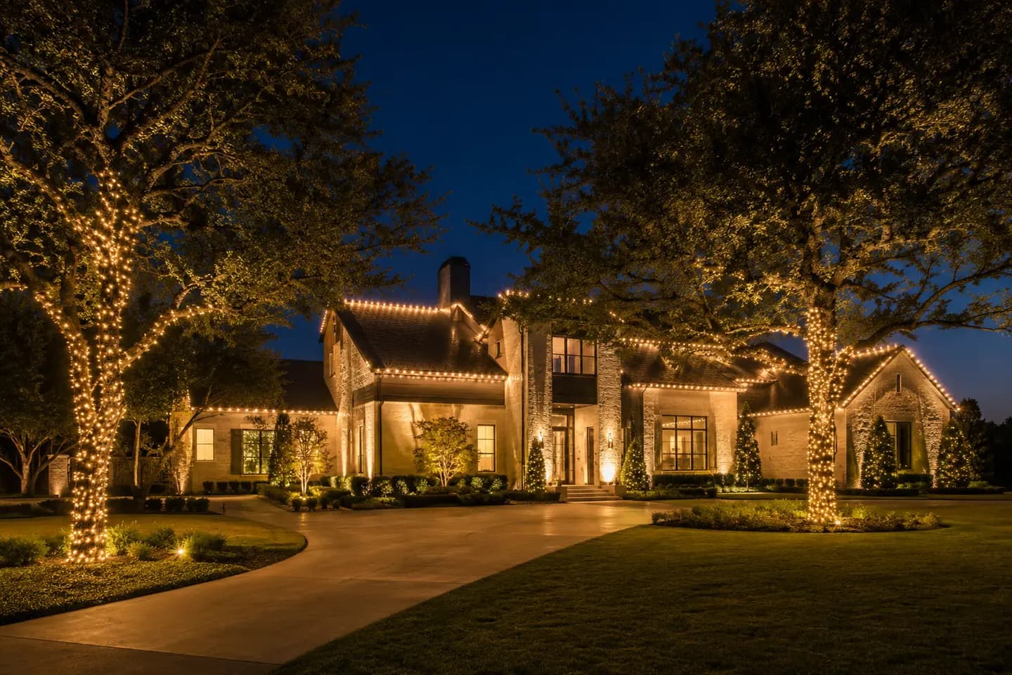 Estate Christmas lighting design visualization with tree wraps and warm-white roofline accents in North Texas