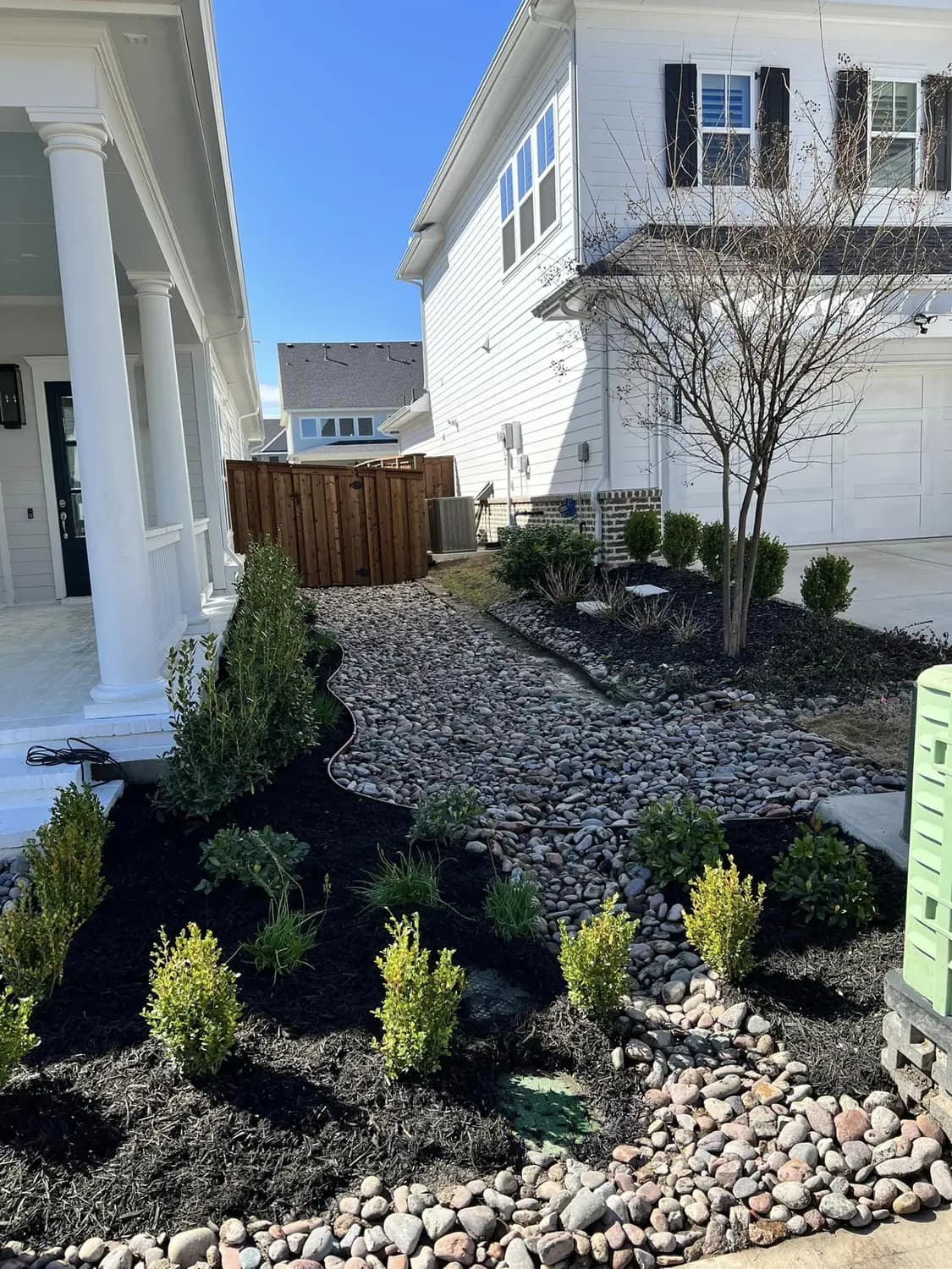 Landmark side-yard landscape using decorative rock and planting around a North Texas home