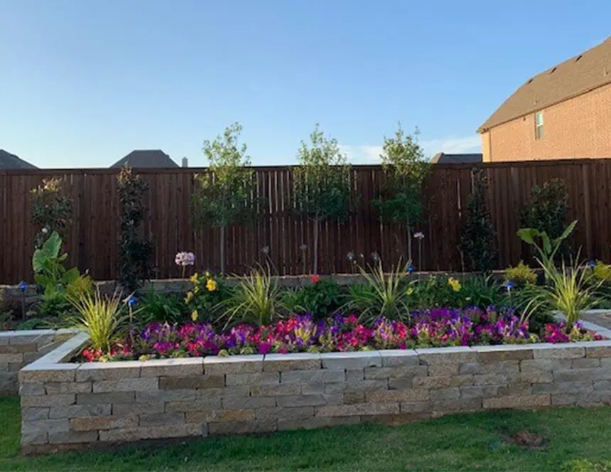 Colorful Landmark planting bed with a stacked natural stone border