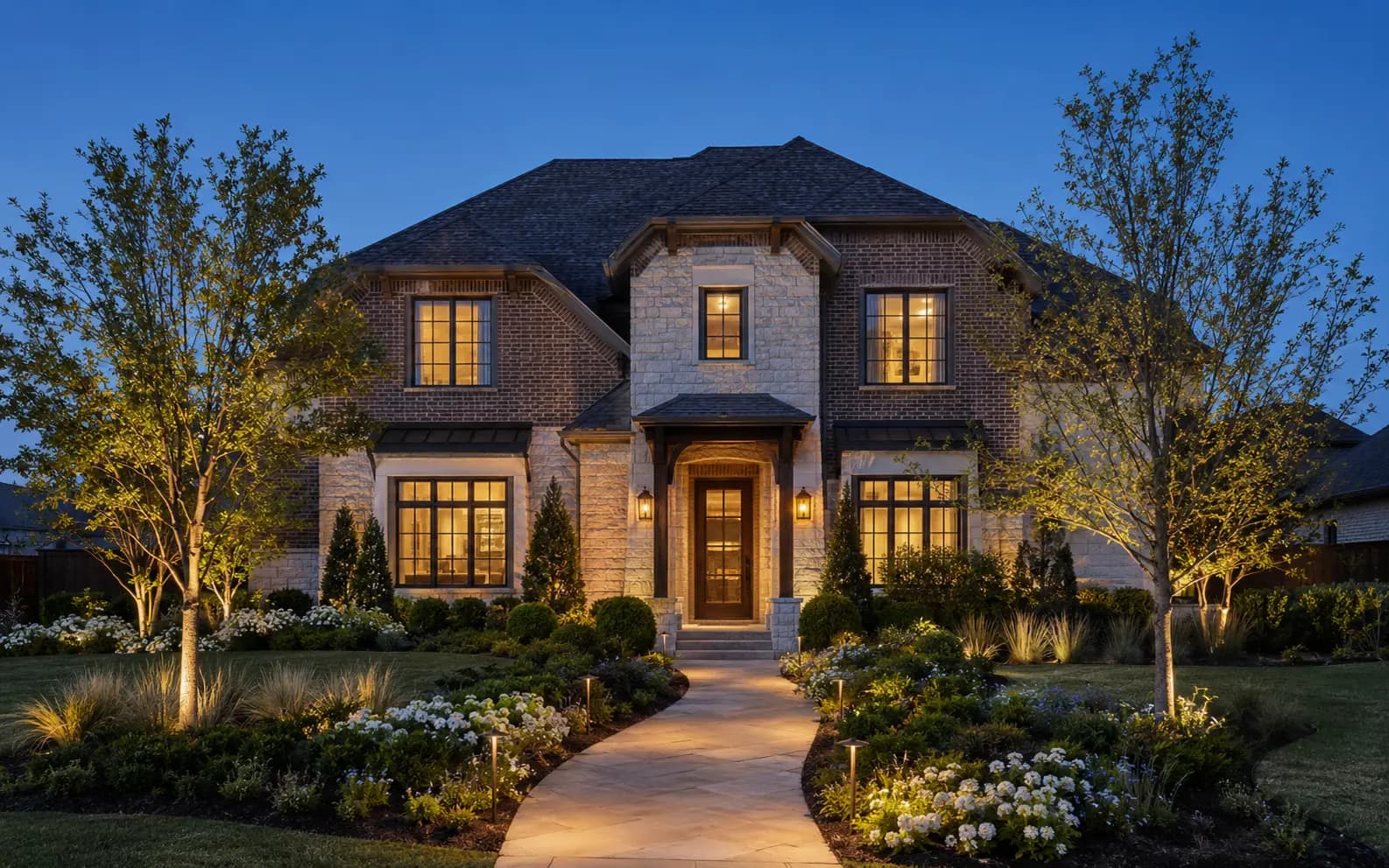 Texas home with warm, subtle landscape uplighting